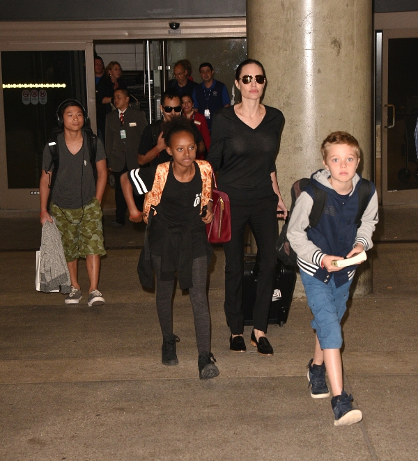Angelina Jolie arrives at LAX airport with her kids - Maddox, Pax, Zahara and Shiloh. Pictured: Angelina Jolie, Kids Ref: SPL1162834 271015 Picture by: MONEY$HOT / Splash News Splash News and Pictures Los Angeles: 310-821-2666 New York: 212-619-2666 London: 870-934-2666 photodesk@splashnews.com 